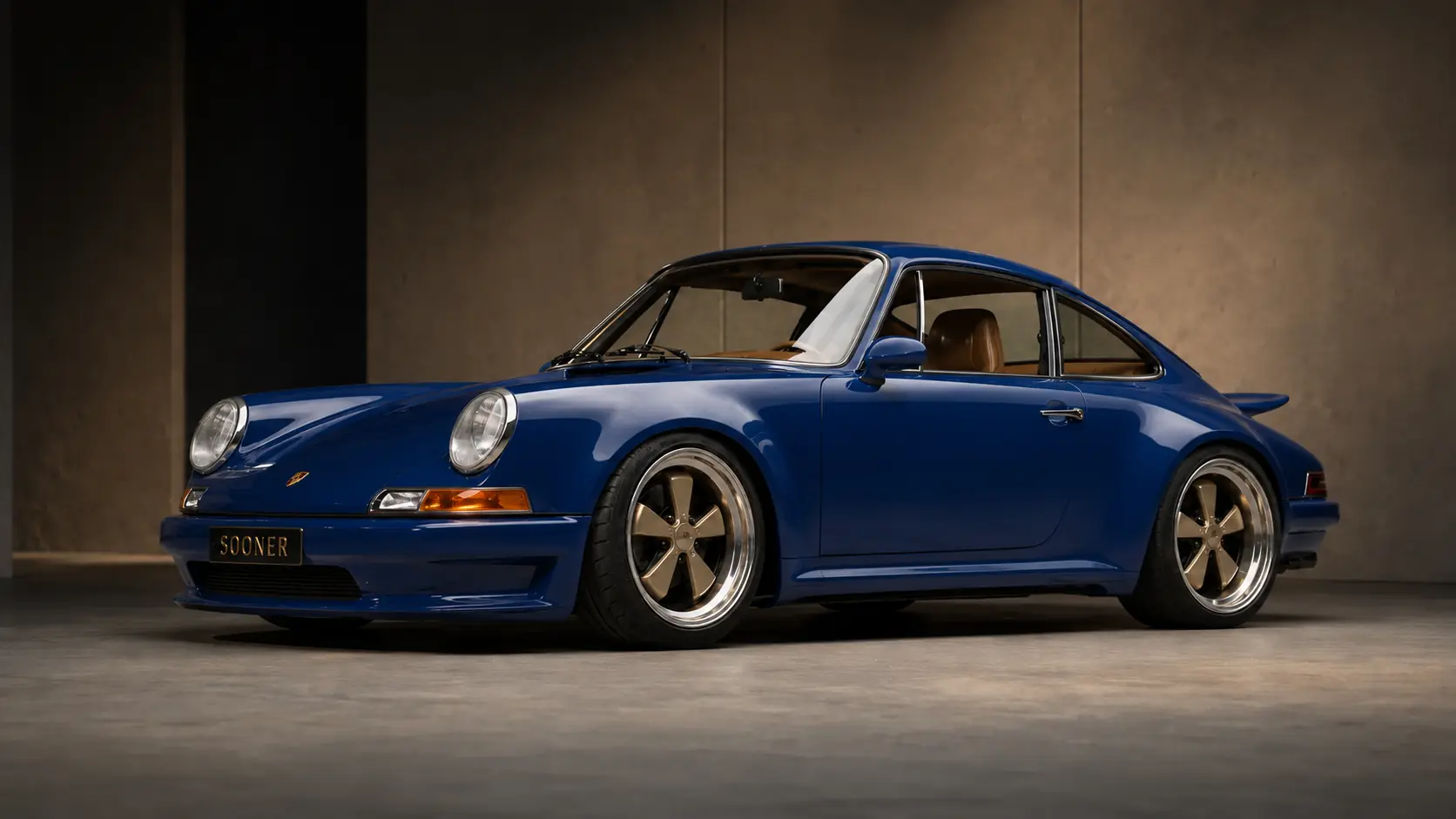 Dark-blue Sooner with restrained aero and champagne five-spoke wheels